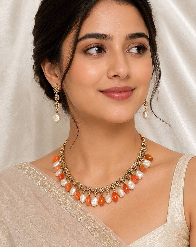Gold-toned necklace set with orange beads and baroque pearls, ethnic indian jewellery, with earrings