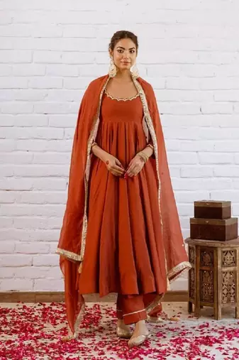 Rust orange solid anarkali kurta with pants and dupatta set