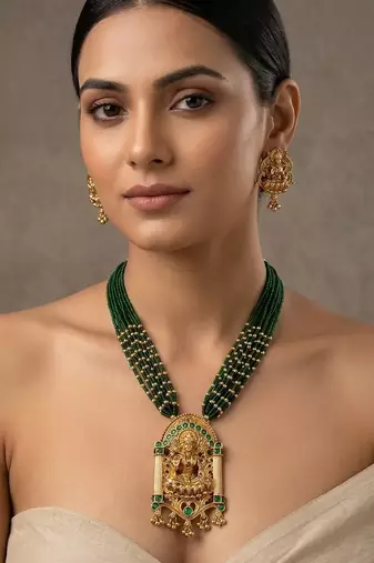 Women gold-plated & green multi-strand lakshmi temple jewellery set