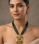 Women gold-plated & green multi-strand lakshmi temple jewellery set