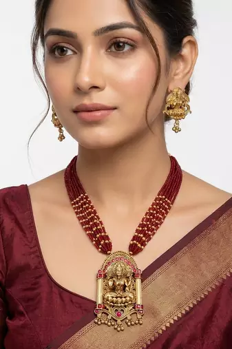 Women gold-plated & green multi-strand lakshmi temple jewellery set