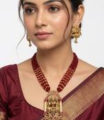 Women gold-plated & green multi-strand lakshmi temple jewellery set