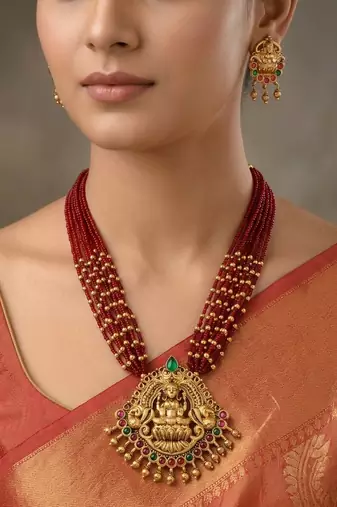 Women gold-plated & ruby multi-strand lakshmi temple jewellery set