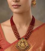 Women gold-plated & ruby multi-strand lakshmi temple jewellery set