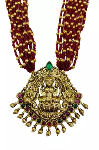 Women gold-plated & ruby multi-strand lakshmi temple jewellery set