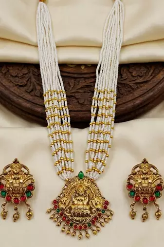 Women gold-plated & white multi-strand lakshmi temple jewellery set
