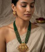Women gold-plated & green multi-strand lakshmi temple jewellery set