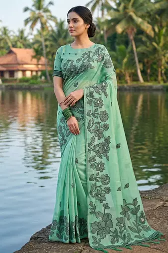 Green colour linen saree with floral jacquard weaving & tassel pallu