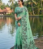 Green colour linen saree with floral jacquard weaving & tassel pallu