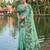 Green colour linen saree with floral jacquard weaving & tassel pallu