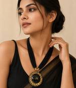 Black multi-strand beaded necklace with round gold leaf pendant, ethnic statement jewellery