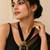 Black multi-strand beaded necklace with round gold leaf pendant, ethnic statement jewellery