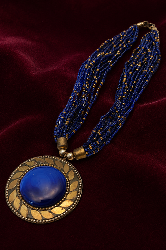 Blue & gold multi-strand beaded necklace with round medallion pendant, boho tribal style