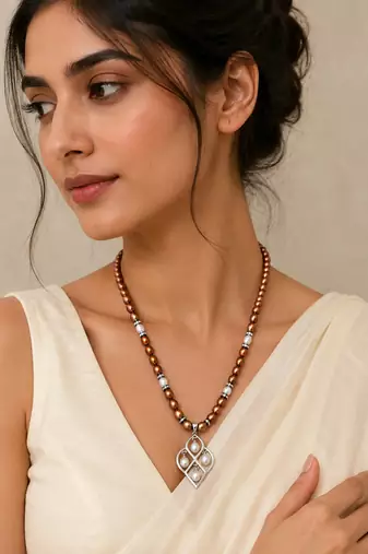 Brown and white pearl beaded necklace with silver geometric pendant, rhinestone accents, magnetic clasp