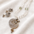 Onyx bead double strand necklace set with kundan peacock pendant and earrings, gold-toned
