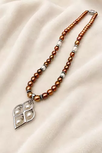 Brown and white pearl beaded necklace with silver geometric pendant, rhinestone accents, magnetic clasp