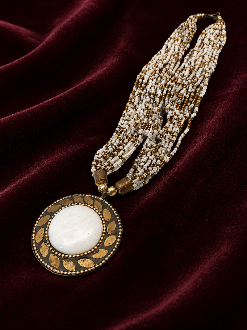 Multi-strand white and gold beaded necklace with round stone pendant, earrings set