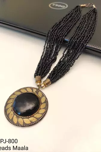Black multi-strand beaded necklace with round gold leaf pendant, ethnic statement jewellery