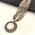 Multi-strand white and gold beaded necklace with round stone pendant, earrings set