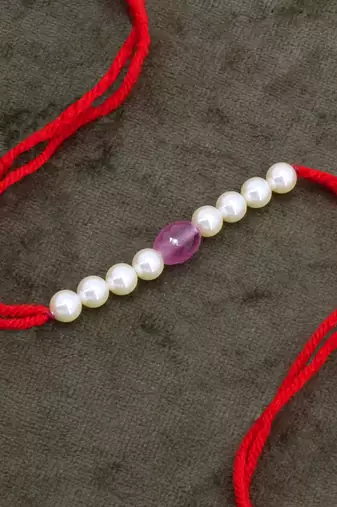 Designer pearl rakhi for brother - traditional pink bead thread