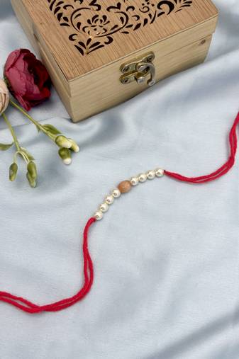 Designer pearl rakhi for brother - traditional peach bead thread