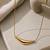 Metallic gold varka crescent pendant necklace