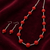 Red beaded necklace and earring jewellery set, silver-tone chain, drop earrings