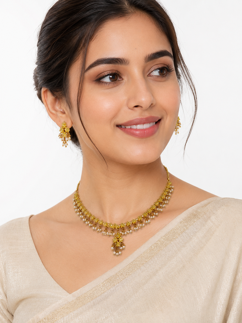 Gold-toned floral necklace and earrings set with pearl drops, traditional indian jewellery
