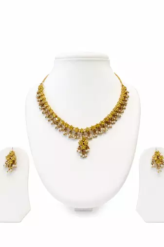Gold-toned floral necklace and earrings set with pearl drops, traditional indian jewellery