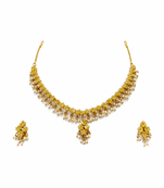 Gold-toned floral necklace and earrings set with pearl drops, traditional indian jewellery