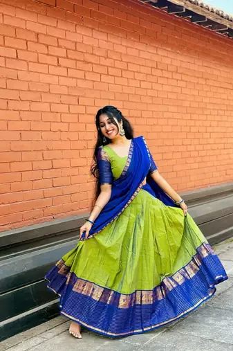 Green kanjivaram silk blend half saree with traditional gold zari weaving work