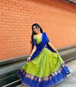 Green kanjivaram silk blend half saree with traditional gold zari weaving work