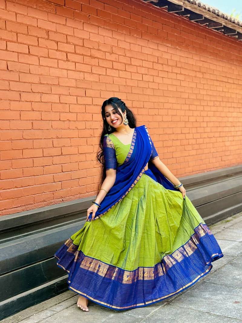 Green kanjivaram silk blend half saree with traditional gold zari weaving work
