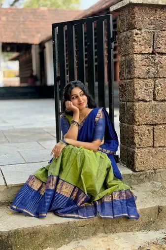 Green kanjivaram silk blend half saree with traditional gold zari weaving work