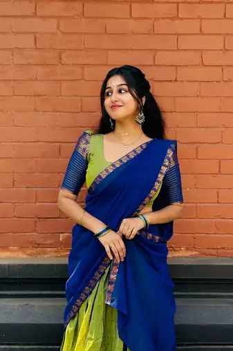 Green kanjivaram silk blend half saree with traditional gold zari weaving work