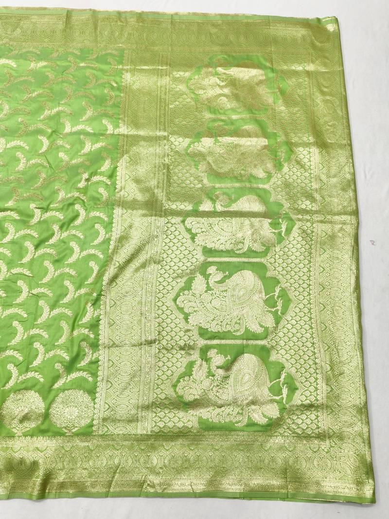 Liight green zari woven banarasi silk blend traditional saree with blouse piece