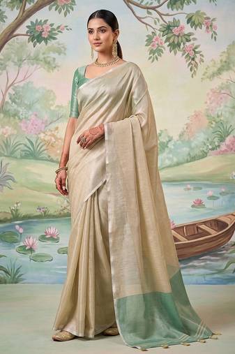 Beige colour tissue silk saree with silver grey pallu & tassels