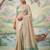 Beige colour tissue silk saree with silver grey pallu & tassels