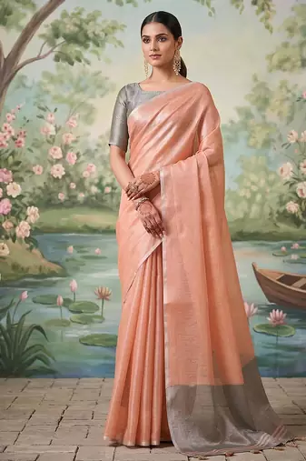 Peach colour tissue silk saree with silver grey pallu & tassels