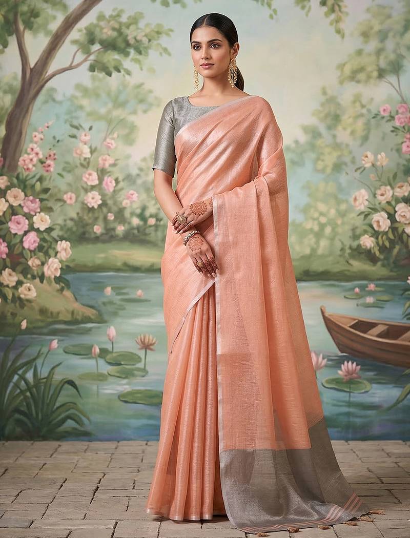 Peach colour tissue silk saree with silver grey pallu & tassels