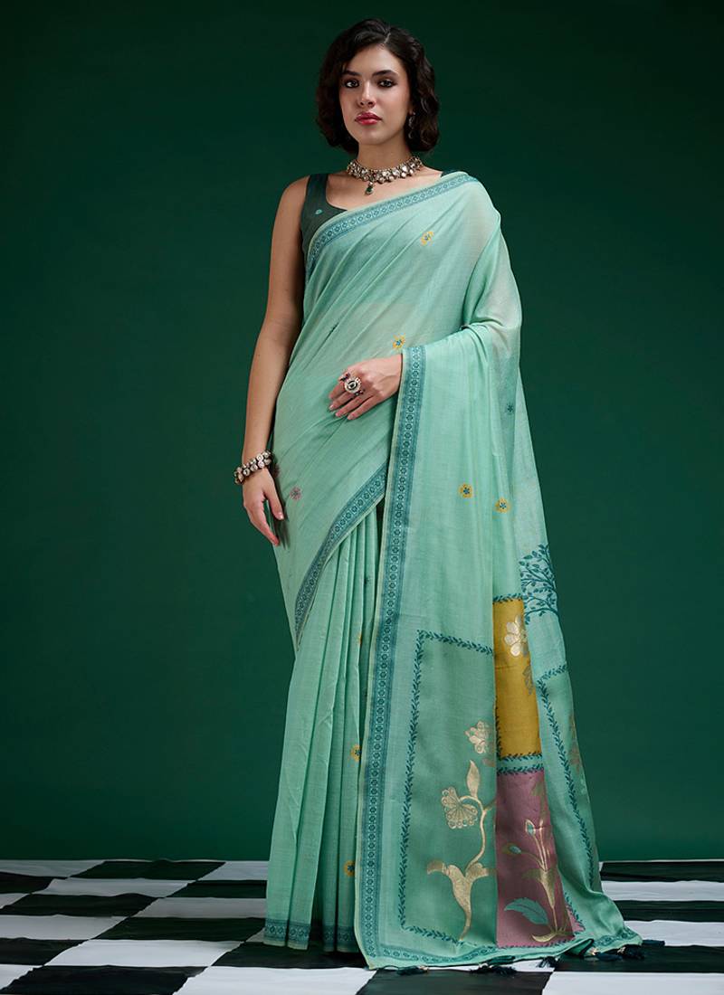 Turquoise handwoven saree with artistic floral patchwork pallu