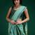 Turquoise handwoven saree with artistic floral patchwork pallu