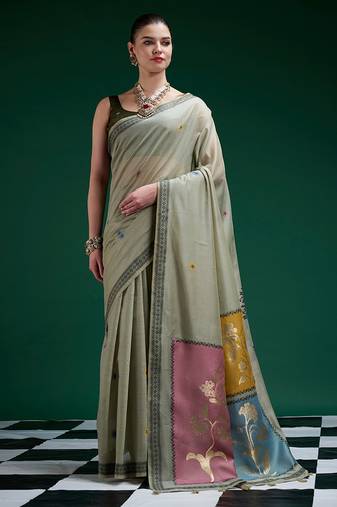Sage green handwoven saree with artistic floral patchwork pallu