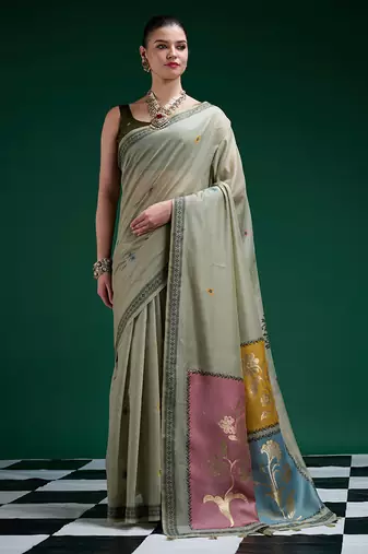 Sage green handwoven saree with artistic floral patchwork pallu