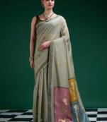 Sage green handwoven saree with artistic floral patchwork pallu