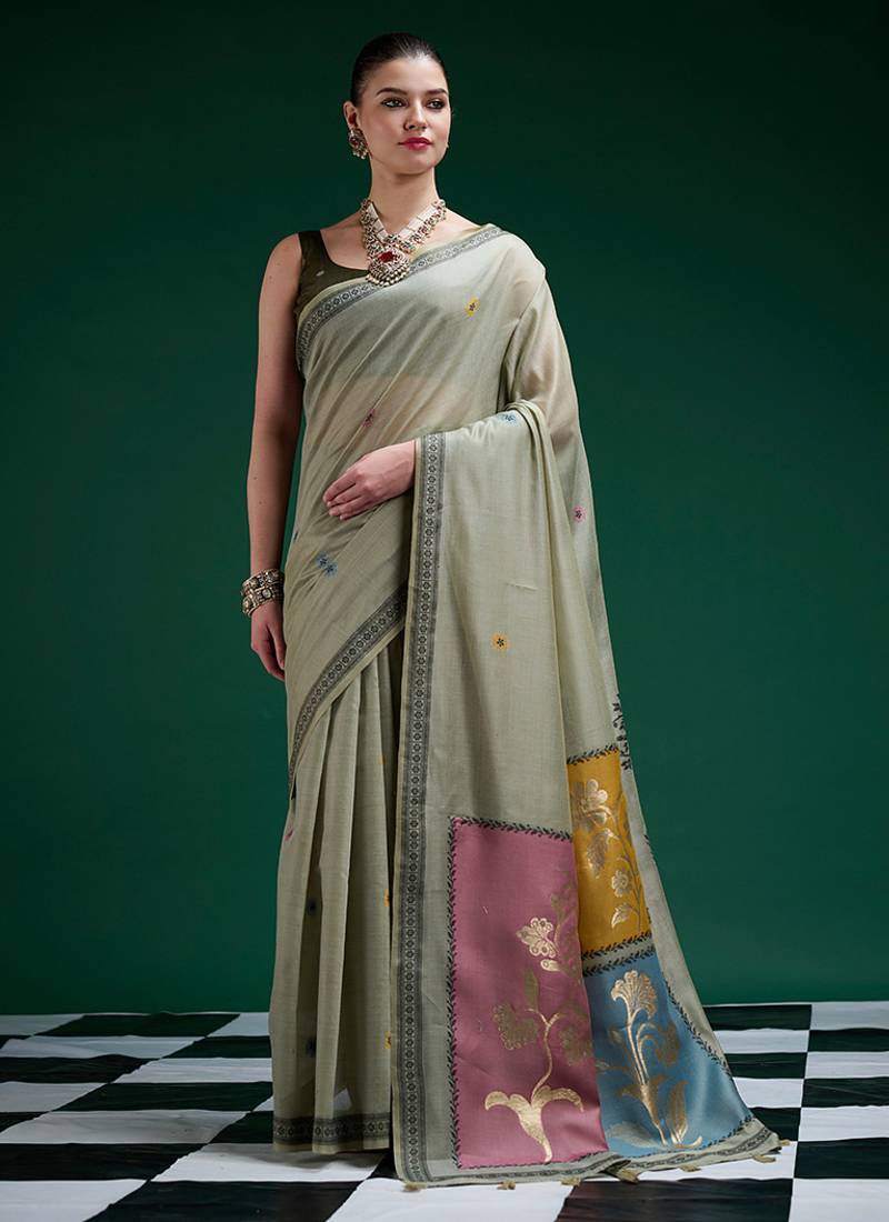 Sage green handwoven saree with artistic floral patchwork pallu