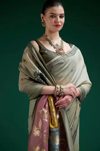 Sage green handwoven saree with artistic floral patchwork pallu