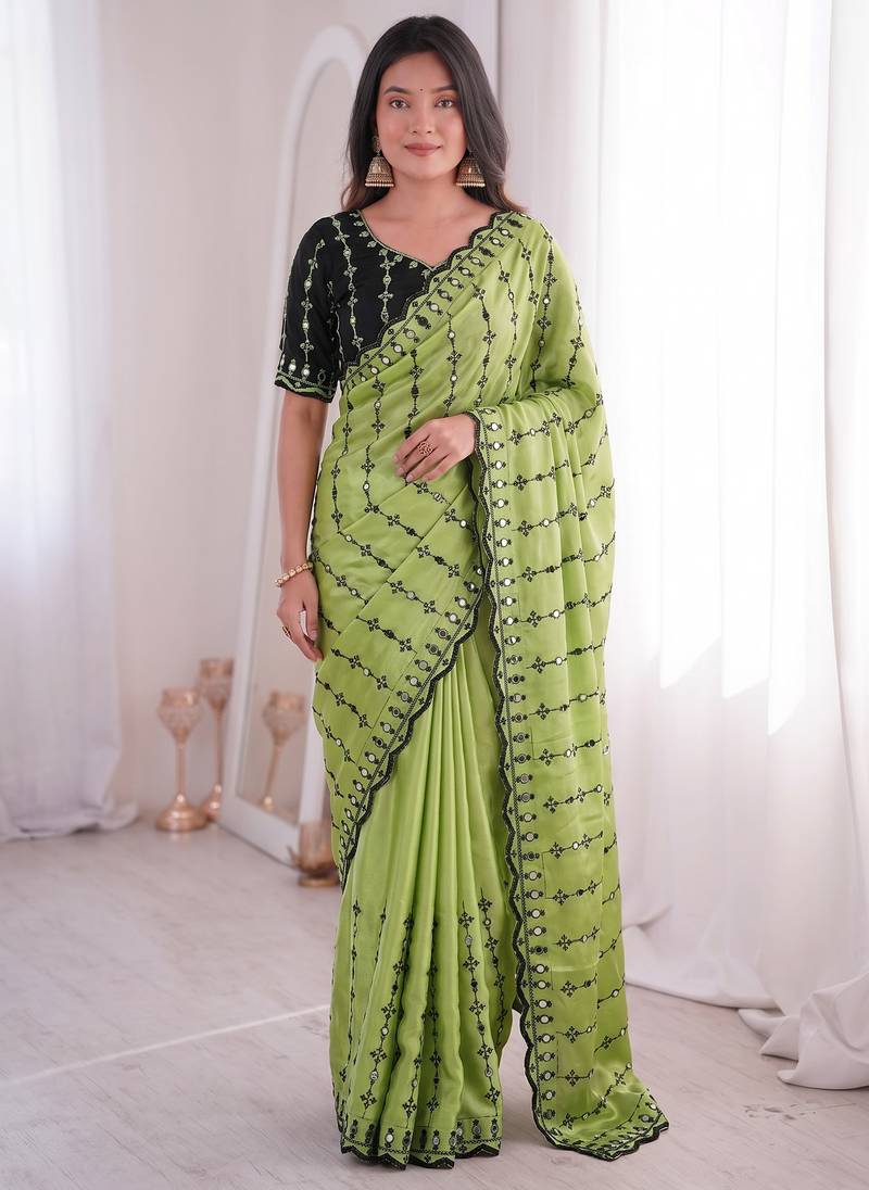 Stunning green viscose rangoli silk saree with black embroidery and mirror work
