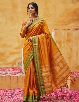 the sunset glow: vibrant orange soft silk blend saree with contrast green zari border 1