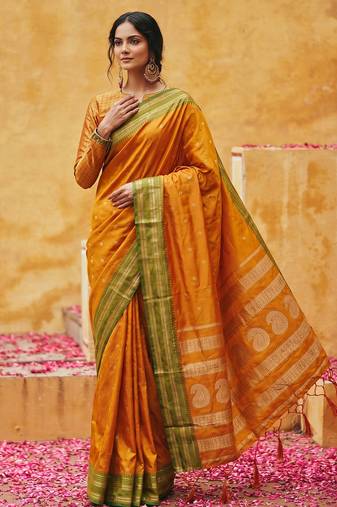 the sunset glow: vibrant orange soft silk blend saree with contrast green zari border